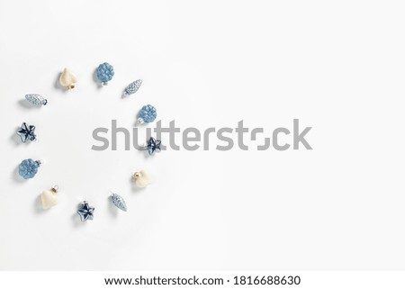 Christmas decor in the form of cones, hearts and stars in blue on a white background. minimalistic new year concept. flat lay, top view, copy space.