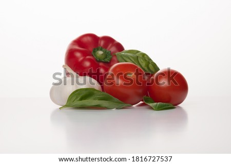 resh vegetables on a white background. Italian ingredients for Gazpacho or tomato sauce: red onion, basil, red pepper, garlic ant tomatoes.   Royalty-Free Stock Photo #1816727537