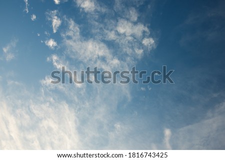 Scattered white clouds on blue sky. Royalty-Free Stock Photo #1816743425