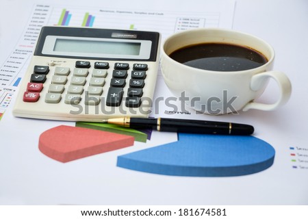 Business report. Cup of coffee on document.