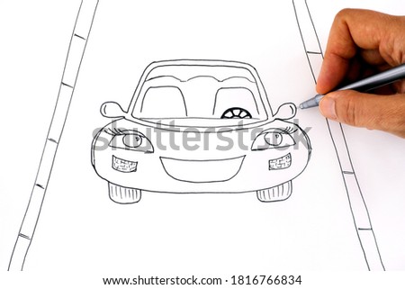 Woman hand with pen drawing picture with Car on a road. Black and white.  