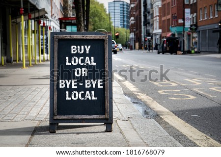 BUY LOCAL OR BYE - BYE LOCAL. Foldable advertising poster on the street