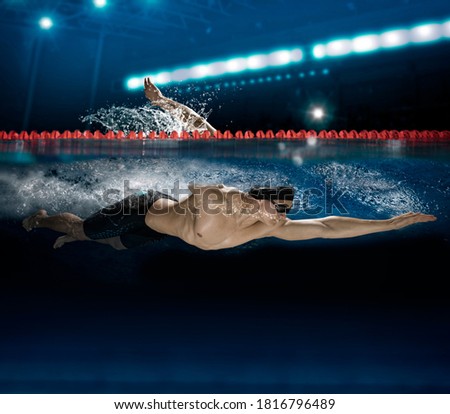 Male swimmer at the swimming pool. Underwater photo. Mixed media