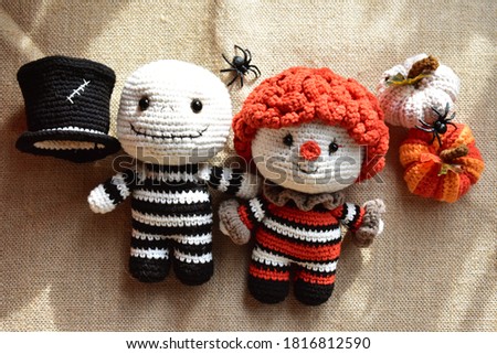 Halloween crochet with cute ghost, pumpkins, clown, spiders, knitting, handmade, kid, childhood, children, funny, toys in canvas/ vintage background