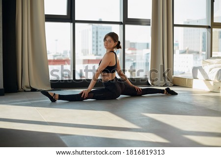 athletic woman stretching in the building.