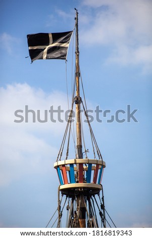 St Piran's flag flying from the crows nest of a ship Royalty-Free Stock Photo #1816819343