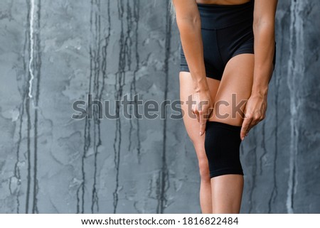 Women's legs with a knee pad for rehabilitation after injuries. Close-up. Royalty-Free Stock Photo #1816822484