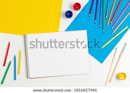 Learning, hobby, art background. Empty sketchbook with art supplies around. Mockup. Top view, flat lay