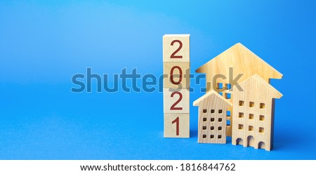 2021 wooden blocks and miniature house. Real estate concept. Family budget planning. Investments, plans, savings. Mortgage and mortgage rates. Forecasts. Loan. Refinance home Royalty-Free Stock Photo #1816844762