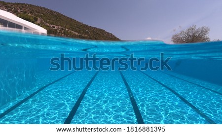 Underwater photo of deep turquoise empty swimming pool