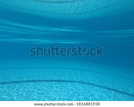 Underwater photo of deep turquoise empty swimming pool