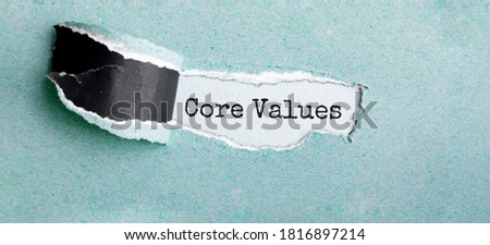 The text CORE VALUES appearing behind torn brown paper Royalty-Free Stock Photo #1816897214