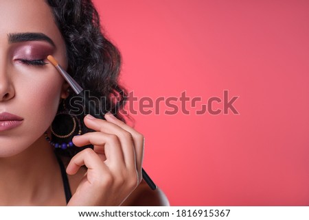 Portrait of a young woman with closed eyes, photo of half the face doing make-up eyelashes with mascara, natural beauty. Evening makeup
