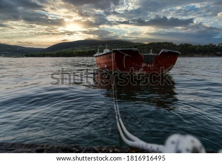 
An old boat foreground.Dramatic sunset in the background