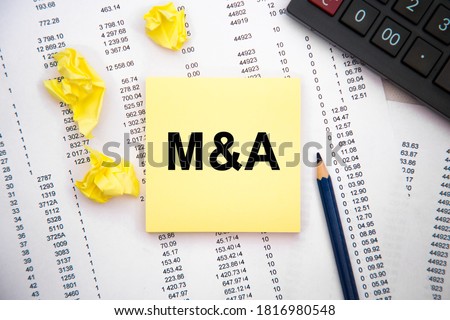M A. notebook paper on table with copy space for text, financial and business planning concept idea.