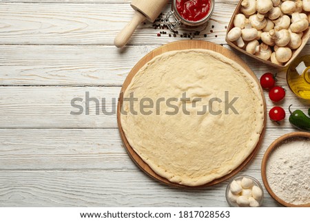 Concept for cooking pizza with ingredients on wooden table
