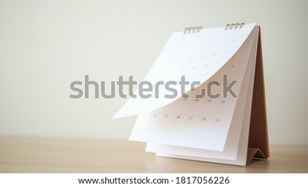 Calendar page flipping sheet on wood table background business schedule planning appointment meeting concept