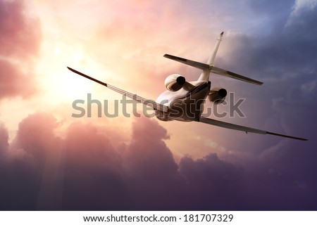 Private Jet PLane in the sky at sunset Royalty-Free Stock Photo #181707329