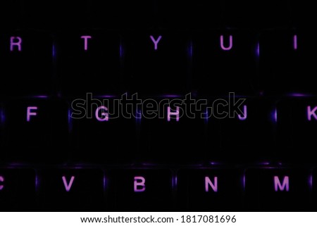Bright purple bright neon letters and numbers on the keyboard. Royalty-Free Stock Photo #1817081696