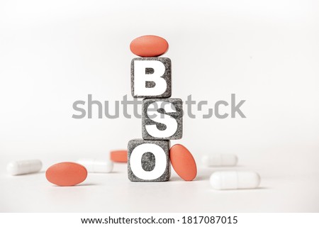 a group of white and red pills and cubes with the word BSO Bilateral salpingo-oophorectomy on them, white background. Concept carehealth, treatment, therapy.