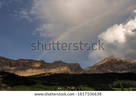 summer rainbow on italian alps in Alta badia