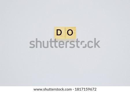 Word do. Top view of wooden blocks with letters on white surface