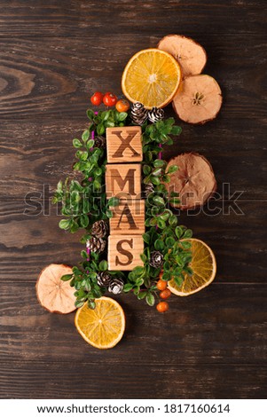 Zero waste Christmas concept. Natural Chirsmas decoration, pine cones and branches on dark rustic wooden background. Flat lay, top view