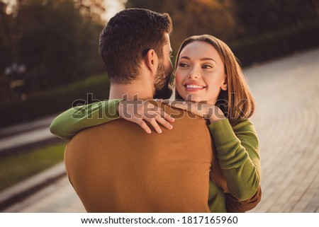 Back rear spine view photo of affectionate couple girl hug her boyfriend in autumn september city center outdoors Royalty-Free Stock Photo #1817165960