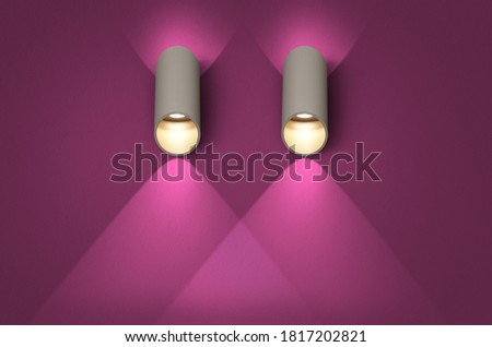 A glowing modern white led lamp on the dark pink wall.