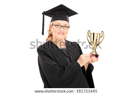 Mature female graduate student holding a gold cup isolated on white background