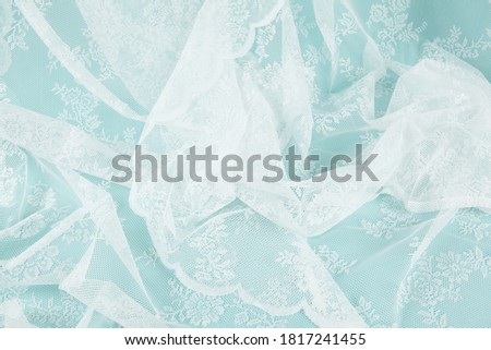  close-up view of a white lace curtain symbolizing the scum of the sea water. Minimal color still life photography 