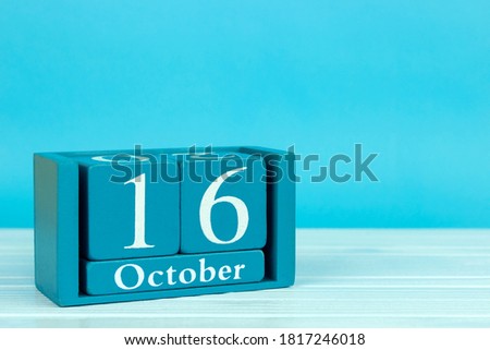 wooden calendar with the date of October 16 on a blue wooden background, World Spine Day; World Anesthesiologist Day; World Day for Healthy Nutrition; World 
foodstuffs day