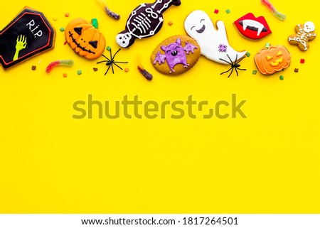 Halloween background concept - gingerbread cookies and candies, top view