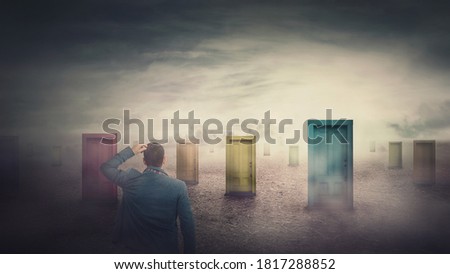 Rear view businessman in front of many different doors choosing one. Difficult decision, important choice, failure or success concept. Decisive ways to unknown future, business opportunity symbol. Royalty-Free Stock Photo #1817288852