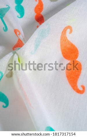 white silk fabric with painted cartoon mustache, red, white, blue and yellow mustache. Texture, background, pattern