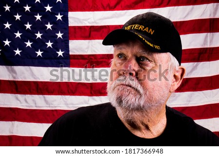 Vietnam Vet With Rough Beard Looking Up With American Flag Backg Royalty-Free Stock Photo #1817366948