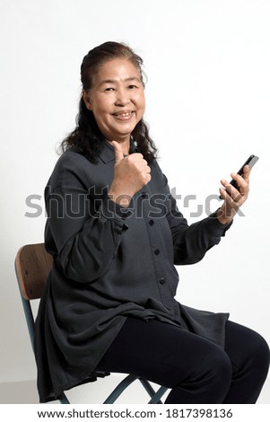 The senior Asian woman on the white background.