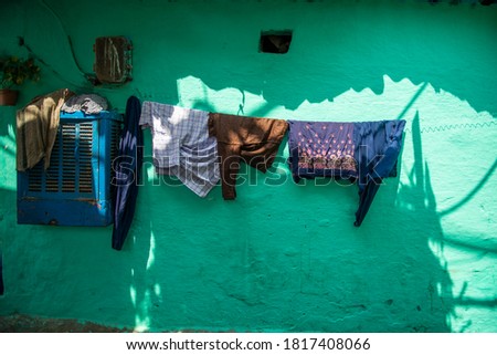 Clothes hanging out to dry in a slum residence .