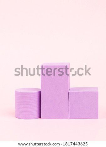 Stack of pink blocks. Geometrical figures still life composition. Platonic solids figures, simplicity concept photography. Pink rectangles and cylinders.