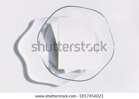 Mockup poster or flyer for presentation, white paper in the glass tray and shadow on a gray background in a elegant modern minimalist style. Congratulations blanks, business cards or invitations. Top