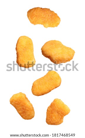 Fresh chicken nuggets falling on white background Royalty-Free Stock Photo #1817468549