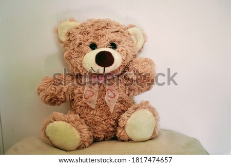 Toy Teddy bear waving at you