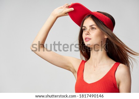 woman in a red cap looking to the side t-shirt close-up