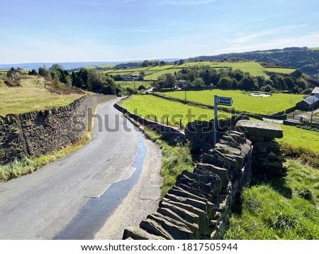 Landscape view at the foot of, Corporal Lane, with fields, dry stone walls, and trees, on a sunny day in, Bradford, Yorkshire, UK