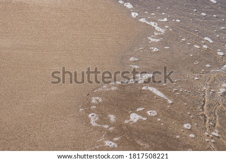 Close-up of the beach and sea level. Seaside texture for background.