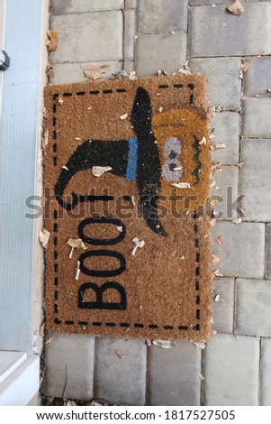 Fun Halloween worried pumpkin front door mat with the word "Boo!"