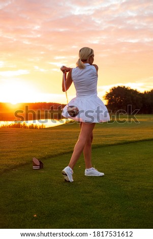 Silhouette of Female in White Uniform Play Golf Outside .