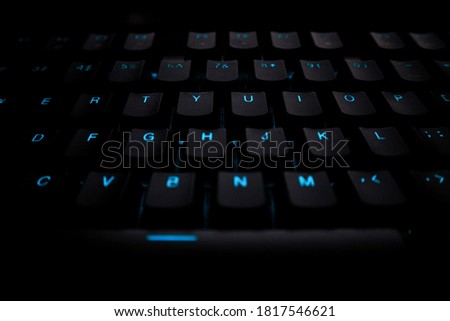 Computer keyboard with blue keyboard backlight Royalty-Free Stock Photo #1817546621