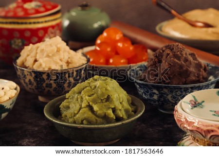 Assorted sweet pastes, salted egg yolk and pastry dough for mooncake Royalty-Free Stock Photo #1817563646