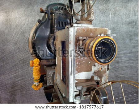 Old style film movie projector with gray background.